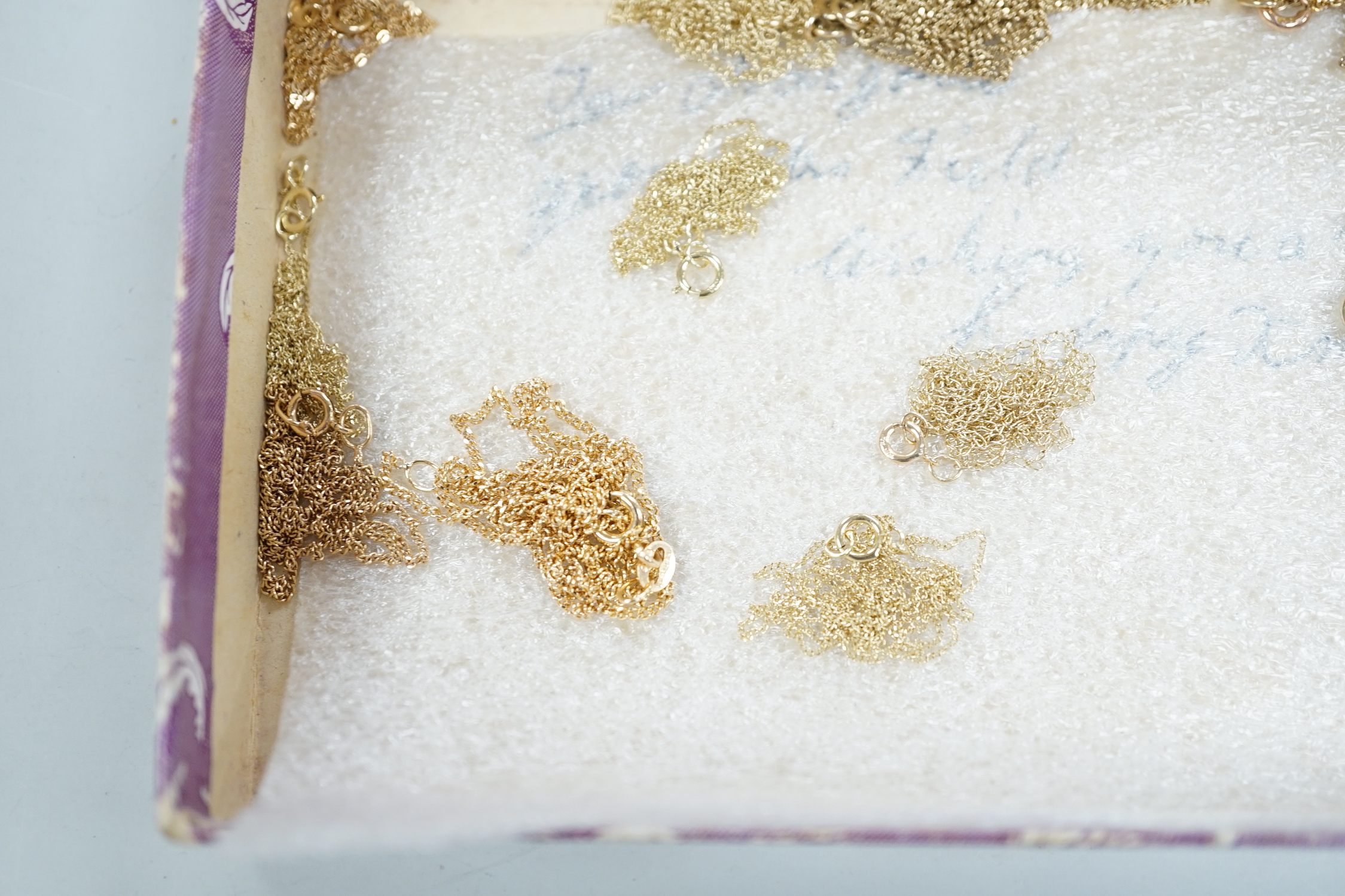 Eleven assorted modern 375 chains and one 10k chain, longest 52cm, shortest 40cm, 13.8 grams.